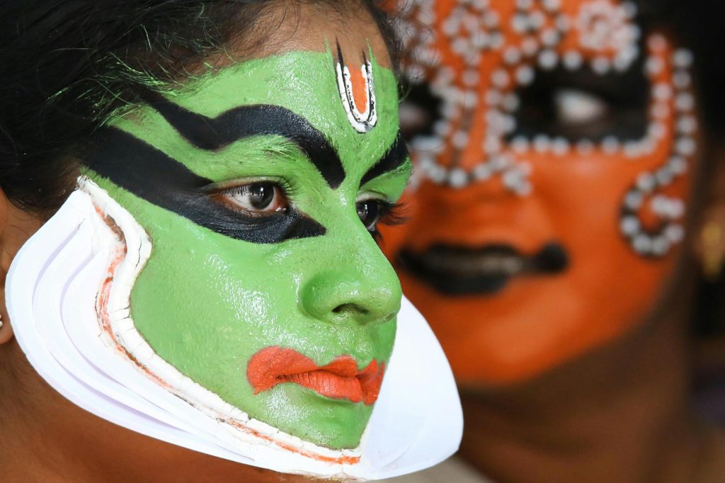 close up of a woman with kathakali dancer face painting