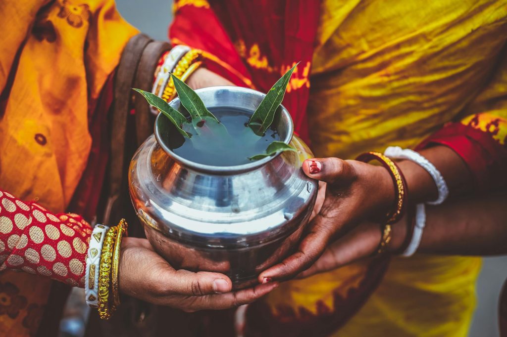 people holding silver metal pot